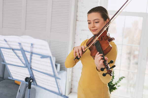Remember solfeggio. Relaxed girl standing in her room while enjoying her improvisation