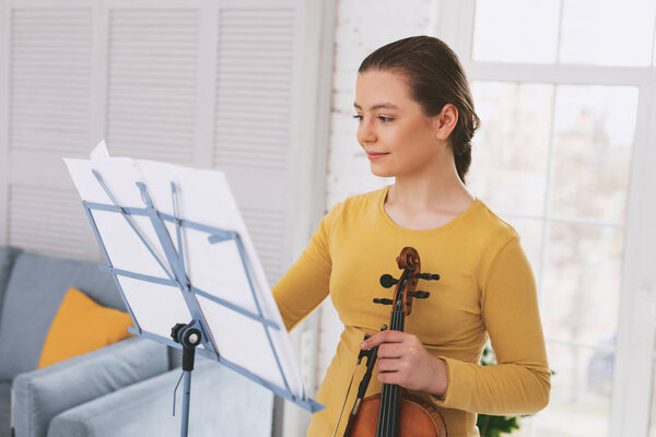 Delighted teenager looking at notes