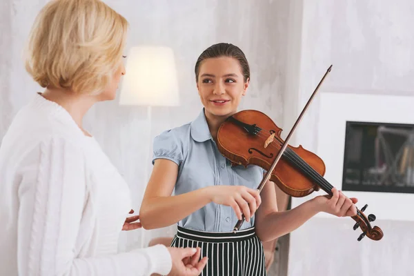 Радостная молодая женщина играет на скрипке — стоковое фото