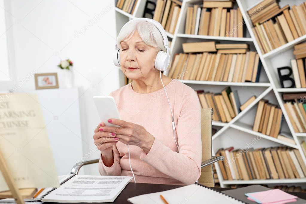 Earnest mature woman learning Chinese