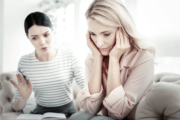 Depressed disappointed woman sitting closing her ears. — Stock Photo, Image