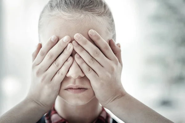 Calm little girl standing hiding her face. — Stock Photo, Image