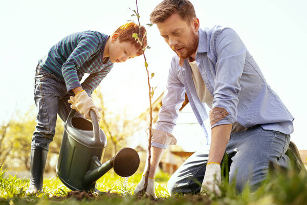 Nice serious man sitting on the ground