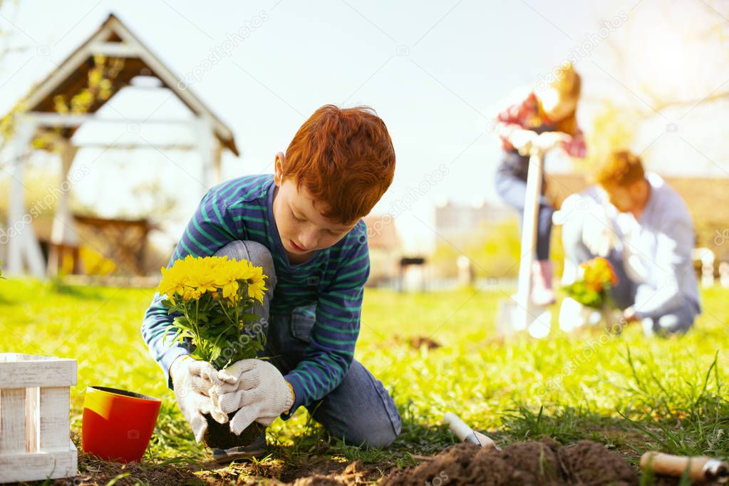 Nice young boy working outdoors