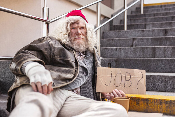 Несчастный бородатый мужчина ищет работу
