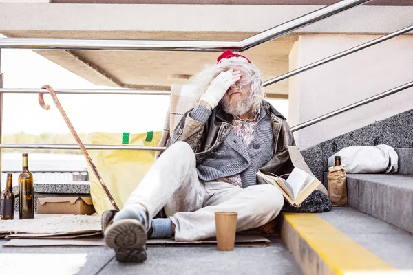 Mutsuz sakallı adam gözlerini kapsayan