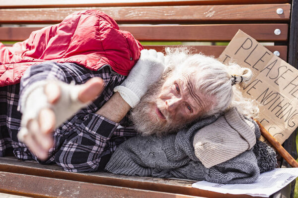 Unhappy poor man looking at you