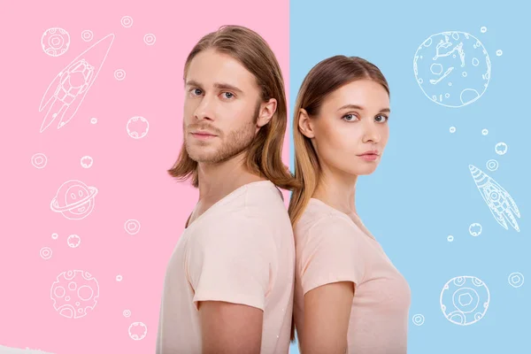 Attractive people standing back to back and dreaming about space — Stock Photo, Image
