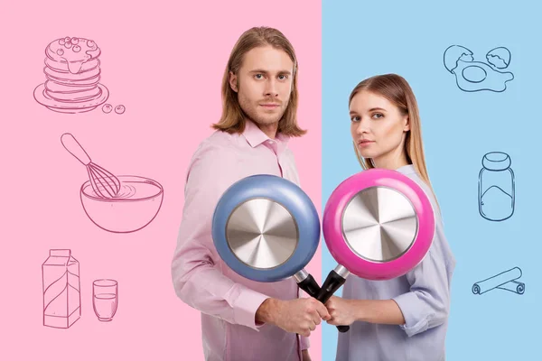 Calm cooks crossing their frying pans and feeling ready to cook — Stock Photo, Image