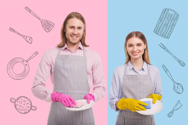 Feliz joven pareja amablemente sonriendo y lavando platos juntos — Foto de Stock