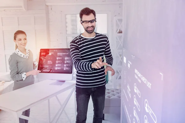 Positive IT manager smiling while wearing virtual reality glasses