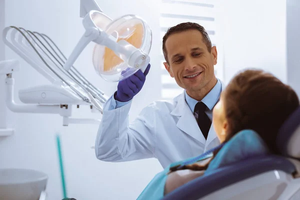 Competent stomatologist treating his patient — Stock Photo, Image