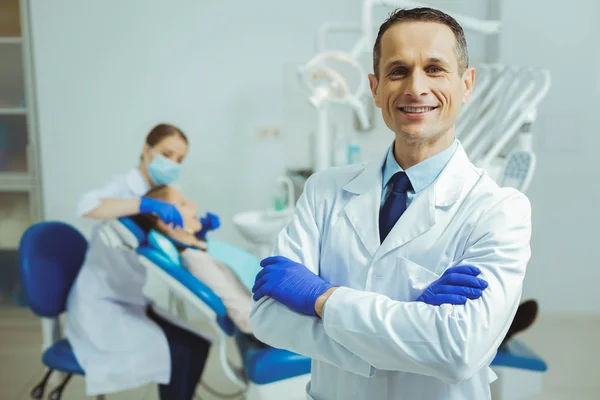 Bonito dentista sorrindo na câmera — Fotografia de Stock