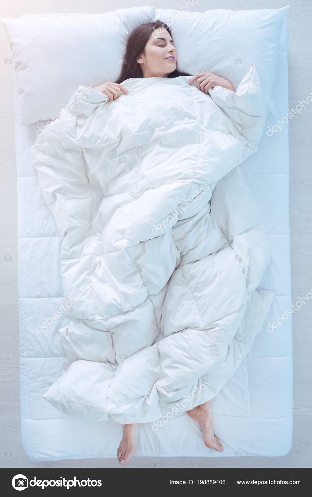 Young lady sleeping in bed with duvet over Stock Photo by ©yacobchuk1
