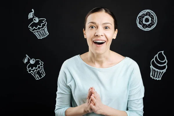 Excited middle aged woman feeling impressed while looking at the cakes — Stock Photo, Image
