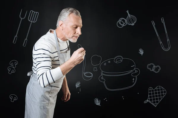 Calm cook closing his eyes while smelling the meal — Stock Photo, Image