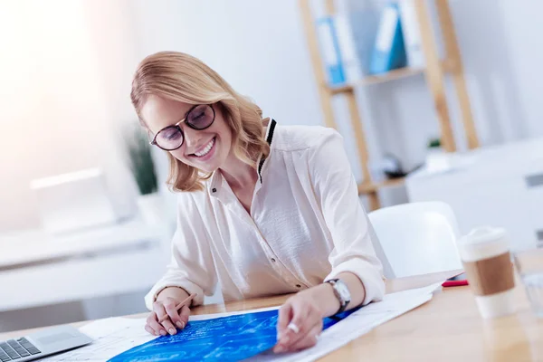 Happy delighted woman looking at the blueprint — Stock Photo, Image