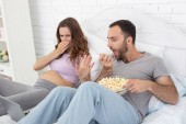 Mad pregnant woman nauseating from popcorn