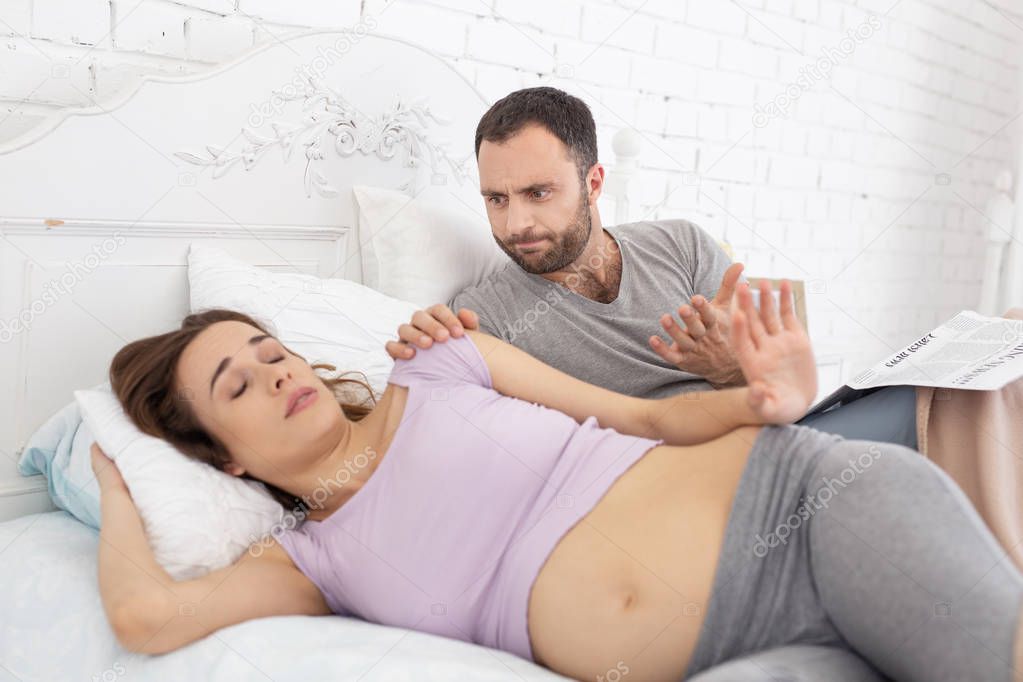 Mad man awaking pregnant woman