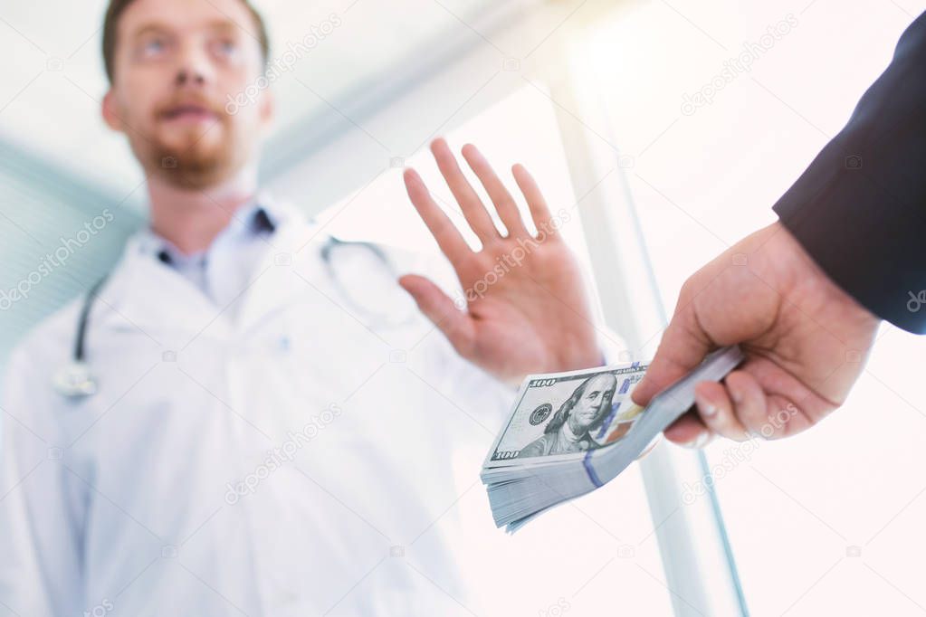 Honest doctor refusing to take a bribe