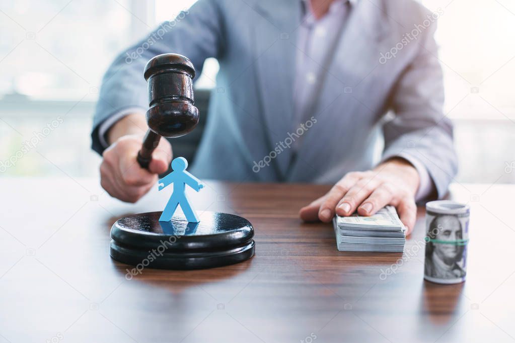 Mean official holding an inscribed gavel