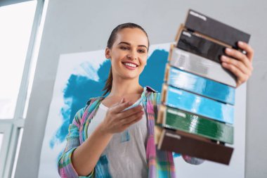 Cheerful woman holding a colour palette clipart