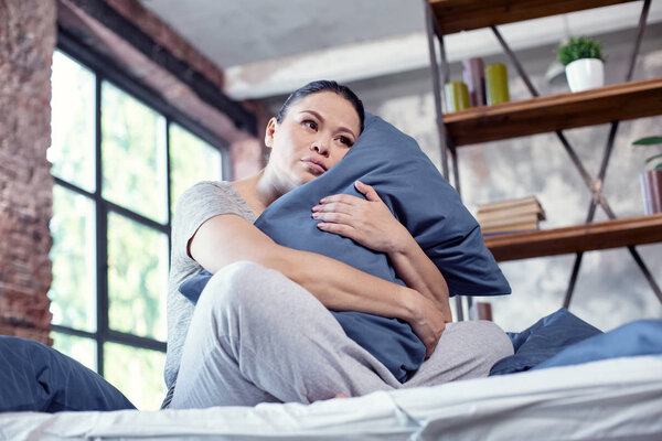 Pleasant gloomy woman undergoing sleep disorder