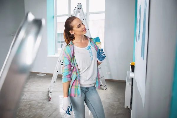 Verheugd vrouw met een borstel voor schilderij — Stockfoto