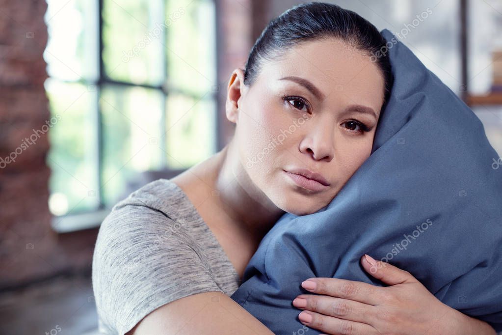 Attractive sad woman enduring sleep disorder