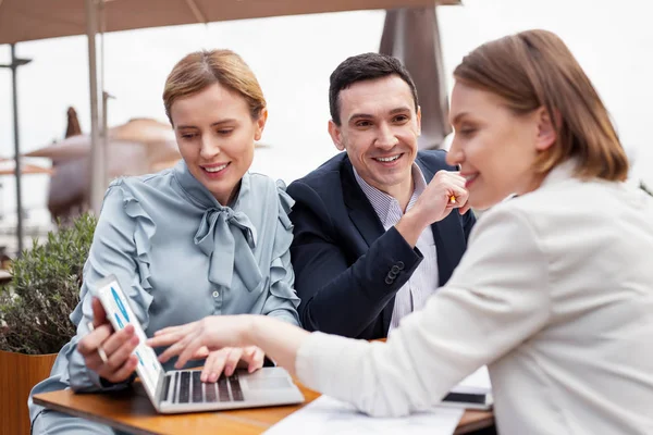 Successful managers watching video report on laptop