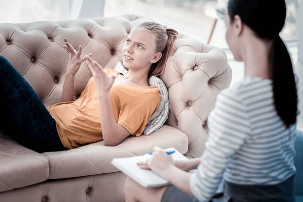 Exalterad tjej gestikulerade samtidigt ha ett samtal med psykolog — Stockfoto