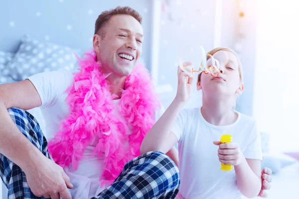 Radieux père et fille soufflant des bulles de savon — Photo