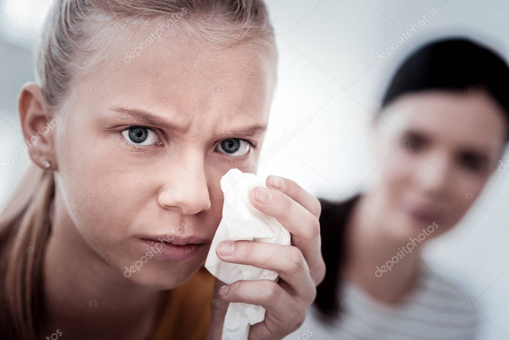 Close up of sad girl with a napkin