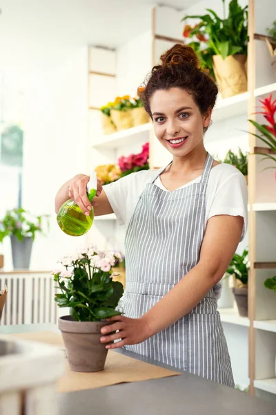 Cheerful happy woman standing near the flower