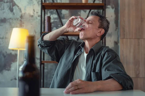 Hombre adicto al alcohol terminando su vaso de whisky — Foto de Stock