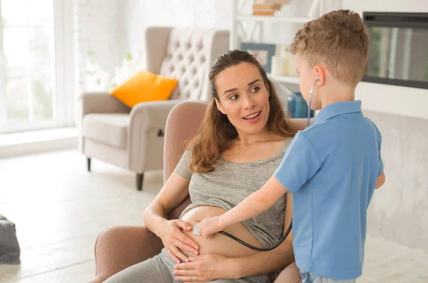 Pregnant future mother sitting in armchair