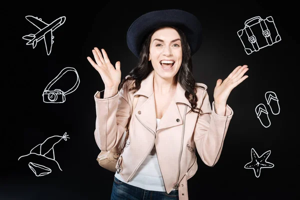 Busy woman putting her hands up while looking forward to her journey — Stock Photo, Image