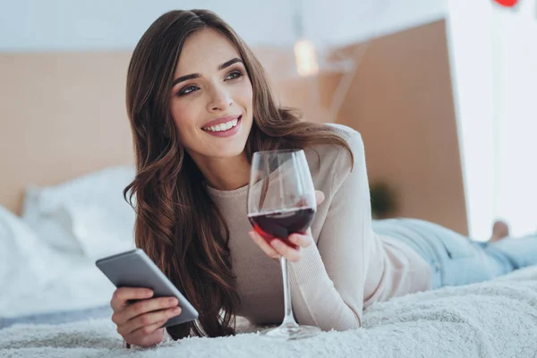 Cheerful delighted woman drinking wine