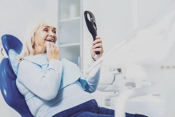 Mujer madura alegre sentado en el gabinete del dentista —  Fotos de Stock