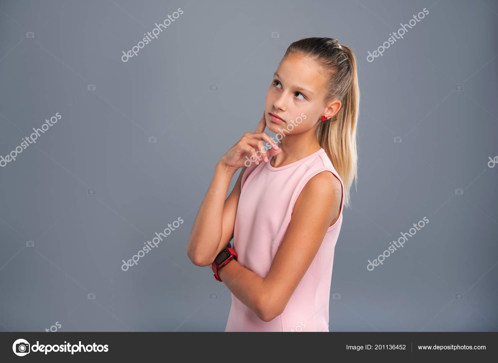 Petite teenage girl contemplating something Stock Photo by