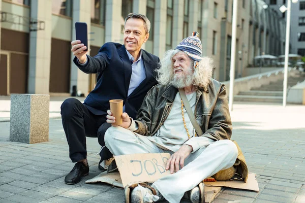 Oficial público de apoio tirando foto com pessoa de rua — Fotografia de Stock