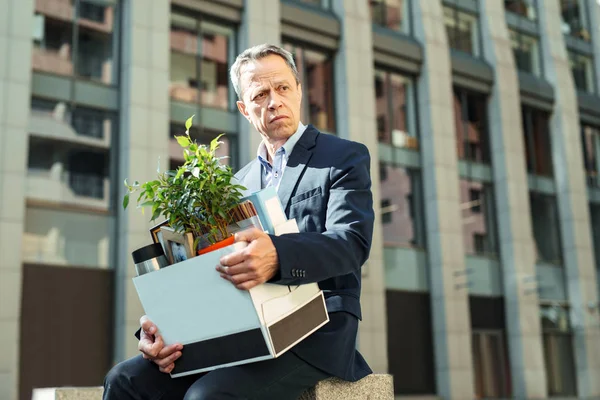 Anciano arrugado gerente de oficina sosteniendo su caja personal — Foto de Stock