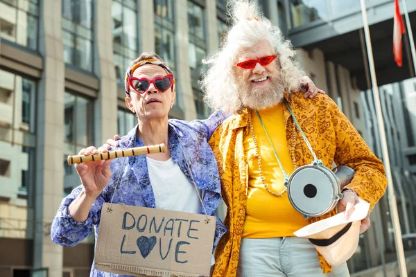 Two bizarre elderly hippies performing in the street