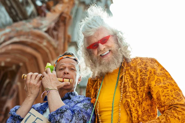 Beaming smiling hippies wearing bright stylish shirts — Stock Photo, Image