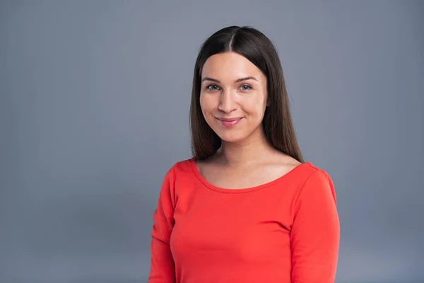 Portrait of a pretty smiling young woman in red pullover — Stock Photo, Image