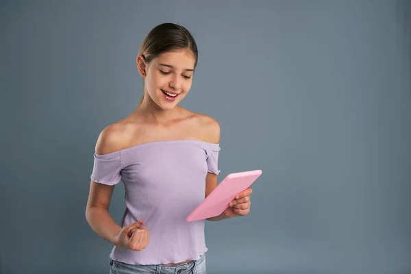 Upbeat teenage girl doing fist pump after reading email — Stock Image Upbeat teenage girl doing fist pump after reading email Stock Image