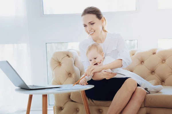 Cheerful businesswoman playing with her child — Stock Photo, Image