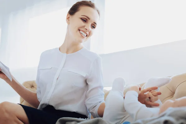 Cheerful female person playing with her baby — Stock Photo, Image