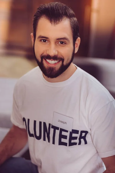 Positive delighted volunteer posing at camera — Stock Photo, Image