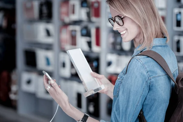 Responsible customer reading a detailed description of a gadget — Stock Photo, Image